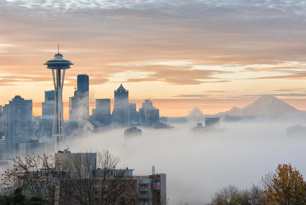Downtown Seattle with the Space Needle and Mt. Rainier with a layer of low fog.