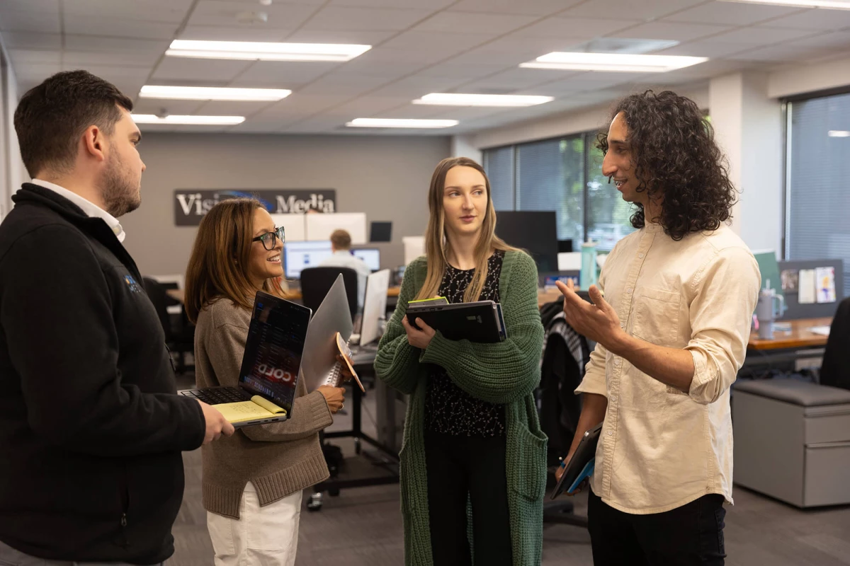Max, Farah, Tianna and Skyler having a stand up meeting