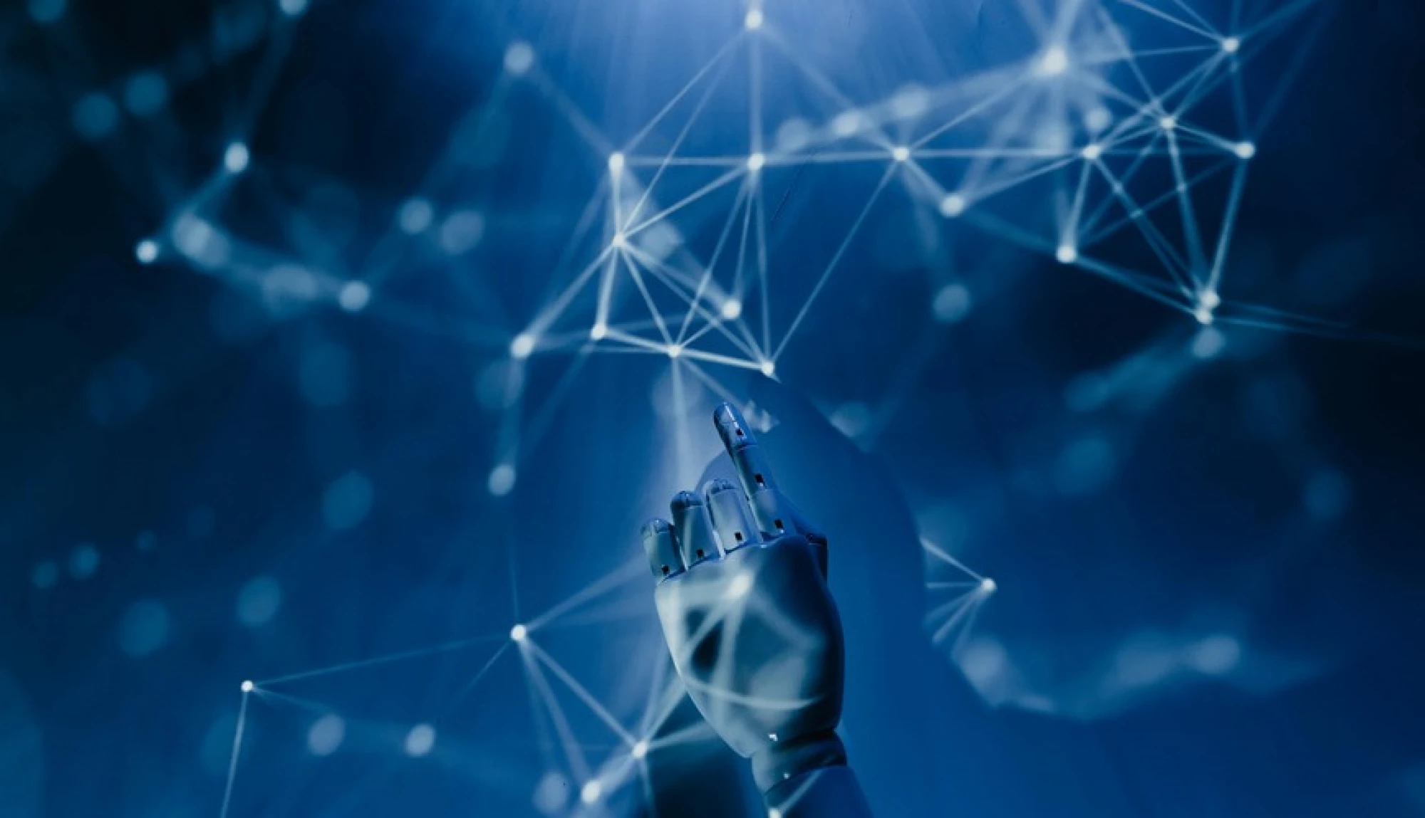 digital hand touching a blue background with constellations