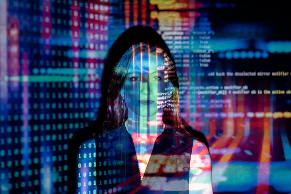 a woman standing behind the projection of colors code