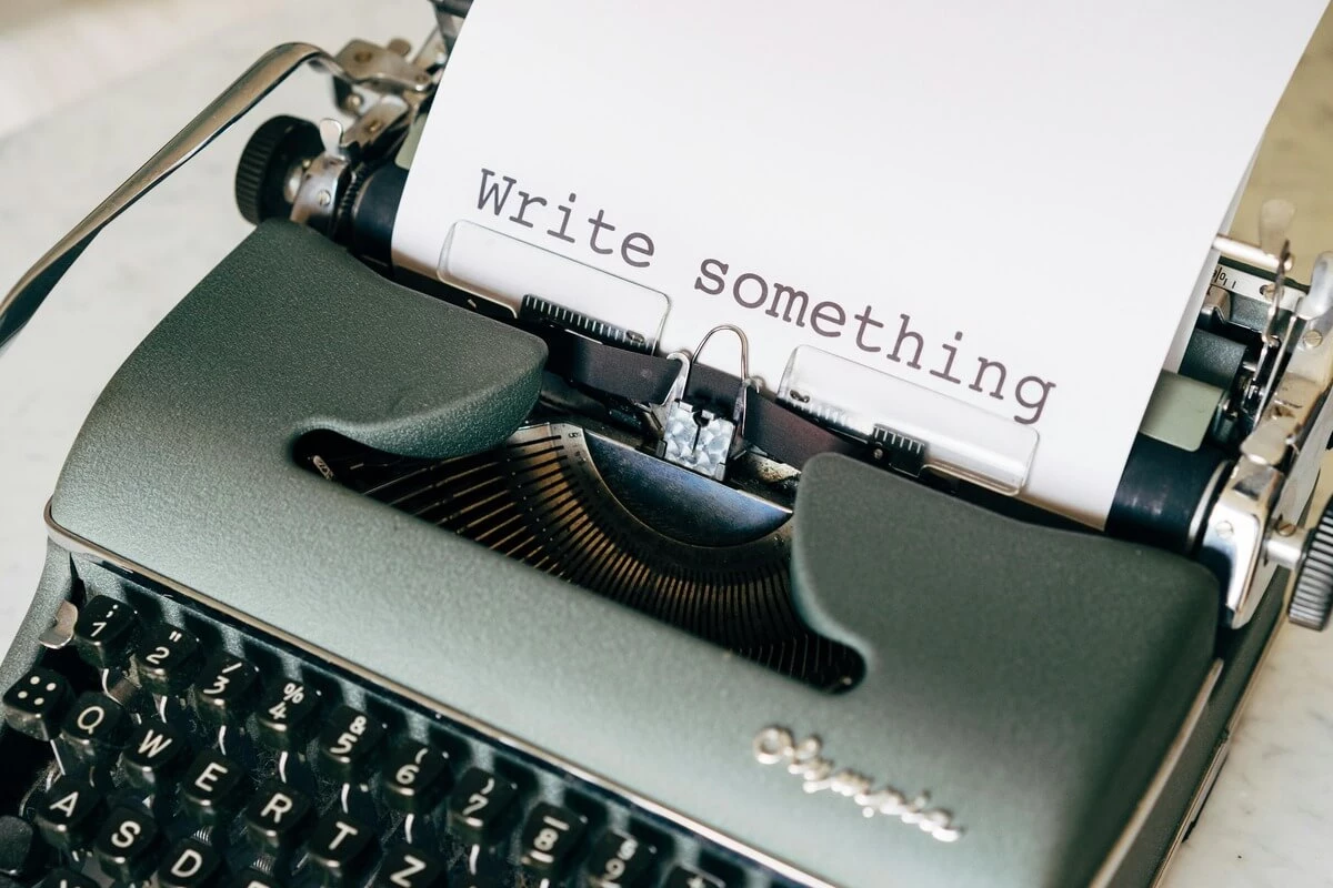 Piece of paper in an old typewriter that ha Write Something on it.