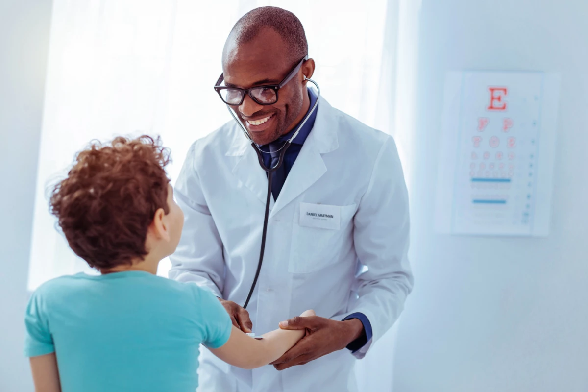 Doctor taking a childss pulse
