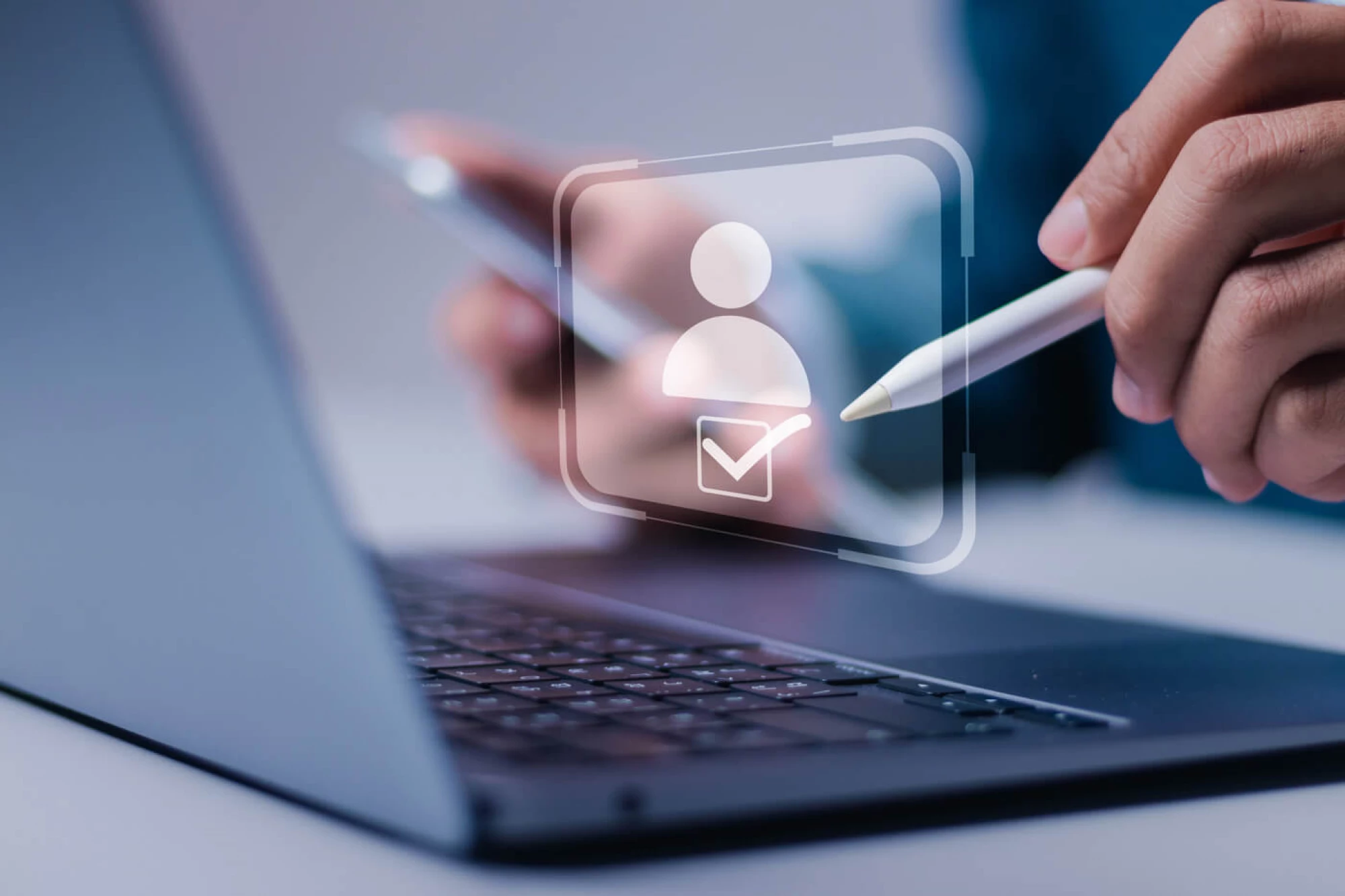 laptop with a floating icon of a illustrated person with a check mark