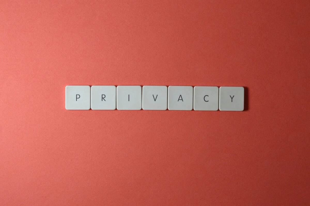 Orange background with Scrabble like tiles spelling out privacy.
