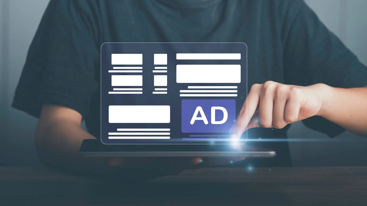 touching laptop with ads