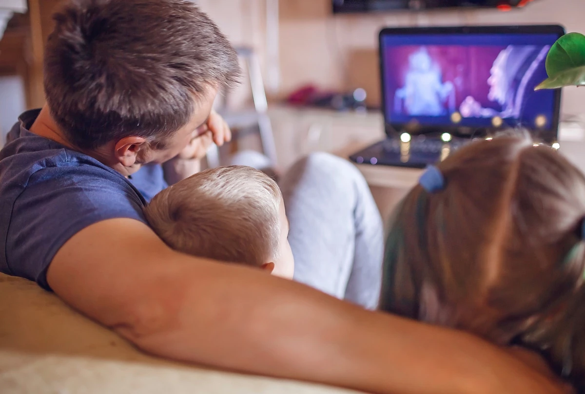 Dad with kids watching tv