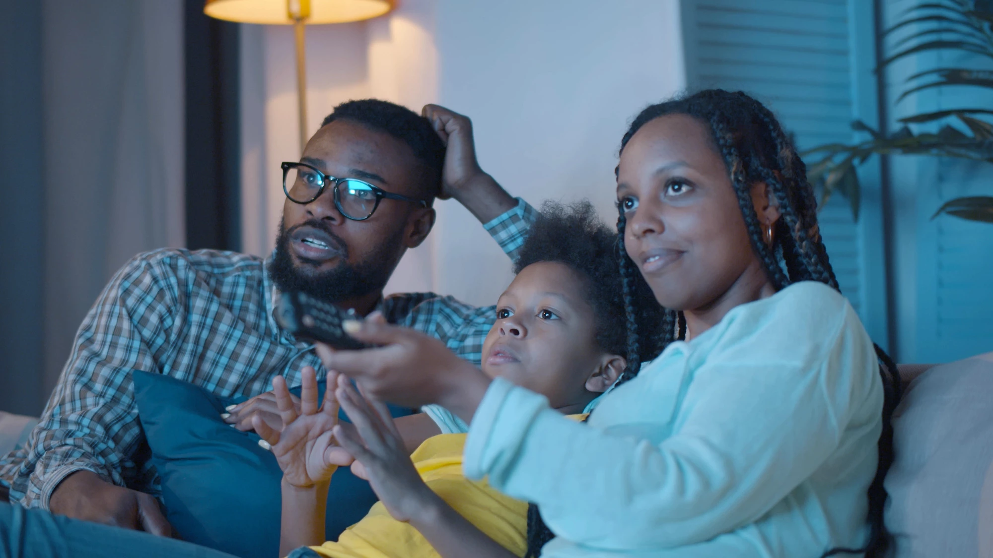 Couple with child watching tv
