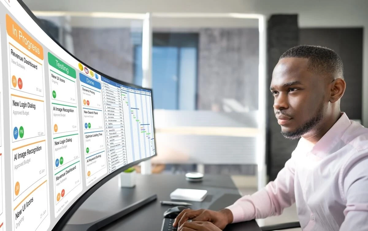 Man watching multiple computer monitors