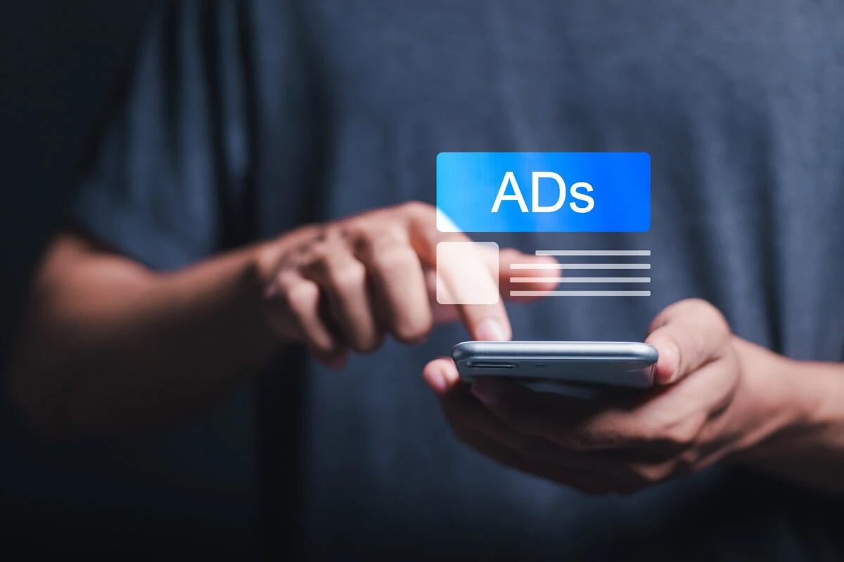 Hand clicking on ad on phone