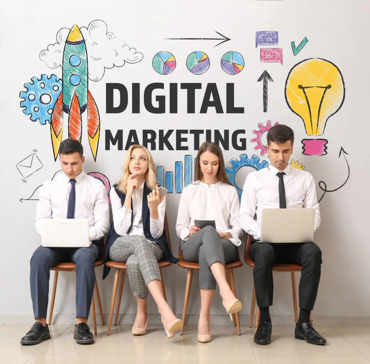 4 marketers in front of a Digital Marketing sign