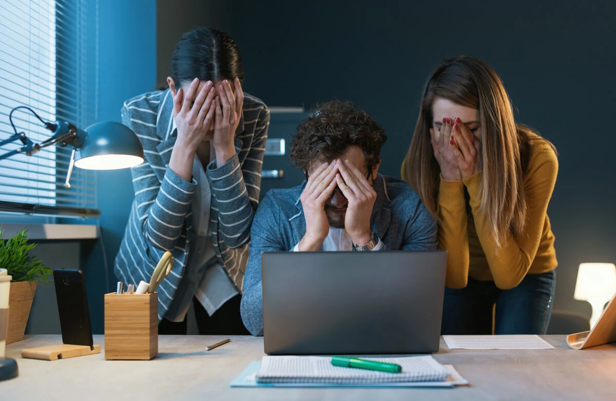 Office workers at desk stressed out